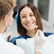 male-professional-dentist-with-gloves-mask-discuss-what-treatment-will-look-like-patient-s-teeth